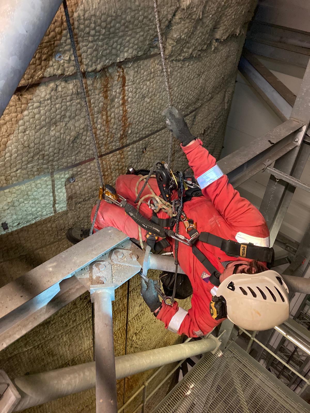 rope access professional from SA Safety. Man dressed in red overalls and safety harness working in a power station