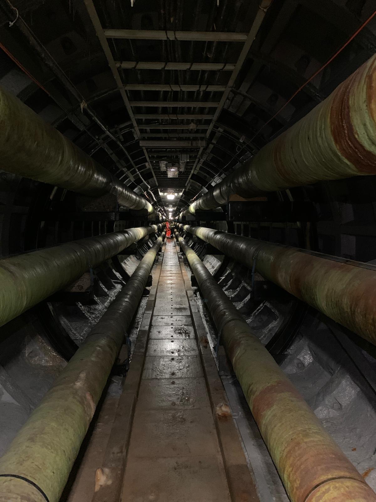Image from a post about rescuer deaths in confined spaces. Image shows a confined space tunnel leading to a light at the end