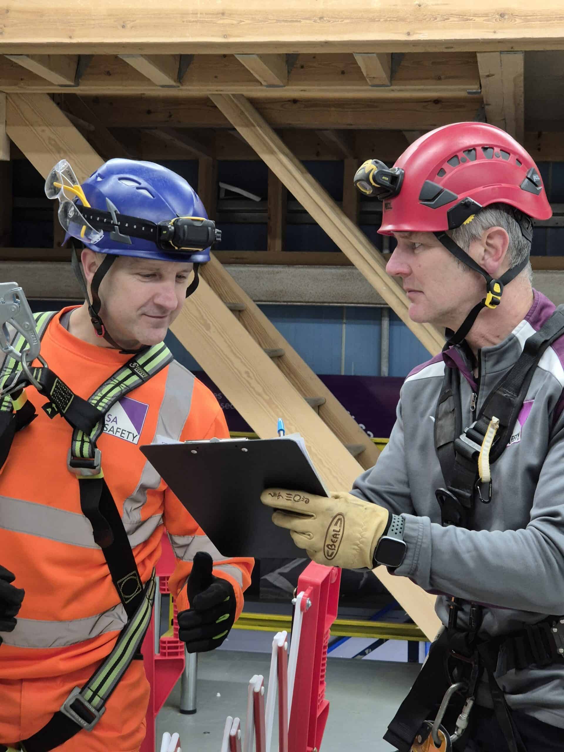 Image shows the trainer/assessor for confined spaces training talking to a candidate on 6160 course